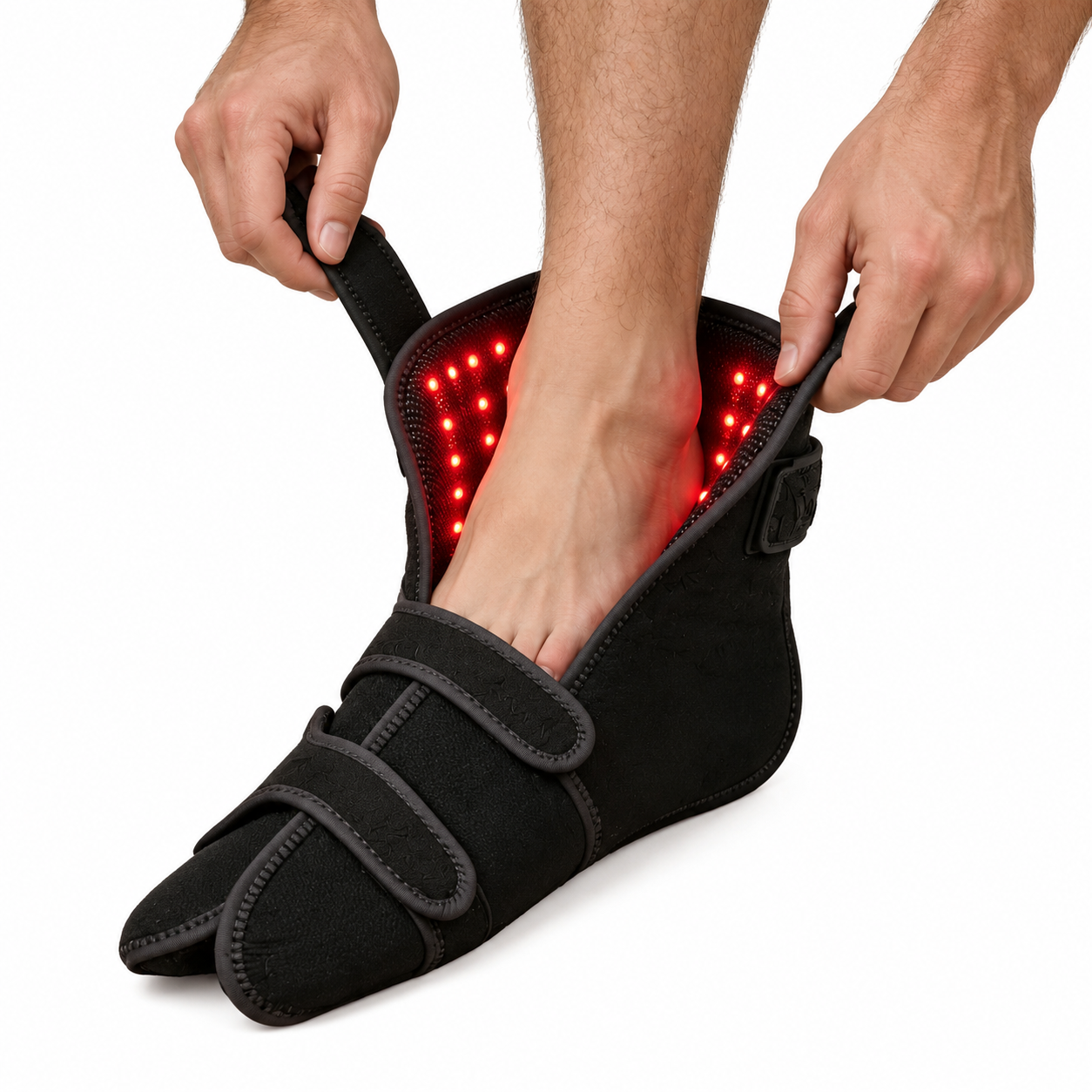 A bare foot sliding into the black Neurava NeuroLight Pro foot wrap, its interior lined with glowing red light panels